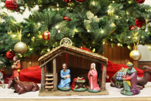 Nativity scene with Mary, Joseph, Jesus along with a donkey, camel, and wiseman under the Christmas tree
